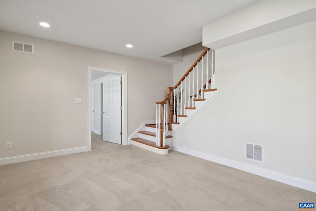 interior space with light colored carpet, stairway, recessed lighting, and visible vents