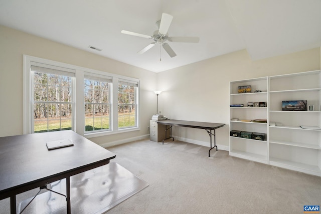 office area featuring visible vents, carpet floors, baseboards, and a ceiling fan