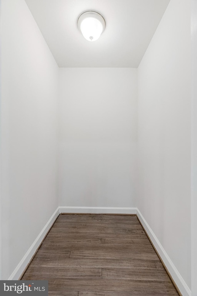 unfurnished room featuring baseboards and wood finished floors