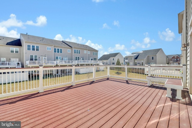 wooden deck with a lawn and a residential view