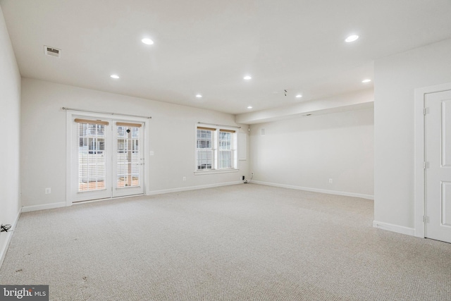 unfurnished room featuring recessed lighting, visible vents, light colored carpet, and a healthy amount of sunlight