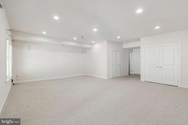 finished basement featuring recessed lighting, baseboards, and light colored carpet