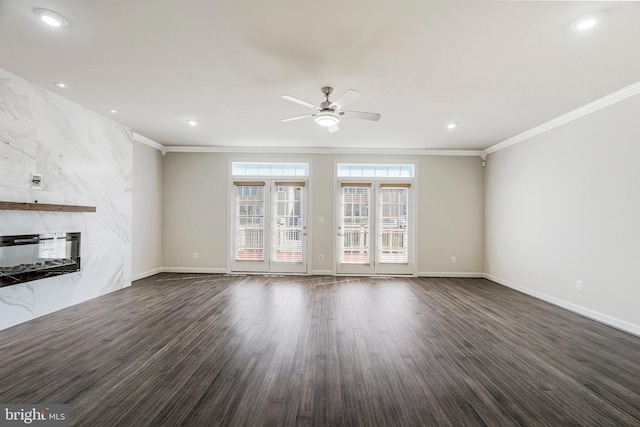 unfurnished living room with heating unit, a ceiling fan, a fireplace, ornamental molding, and dark wood-type flooring