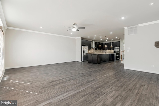 unfurnished living room featuring visible vents, baseboards, dark wood-type flooring, and ornamental molding