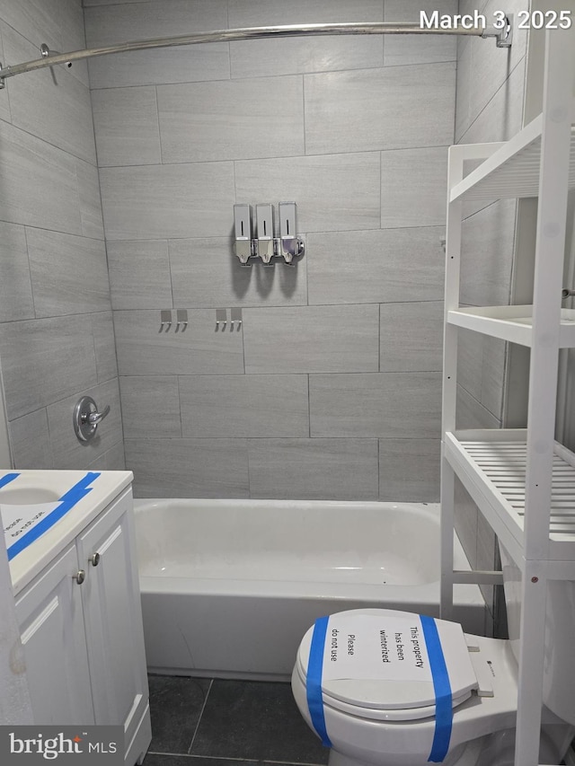 bathroom featuring shower / tub combination, toilet, vanity, and tile patterned flooring