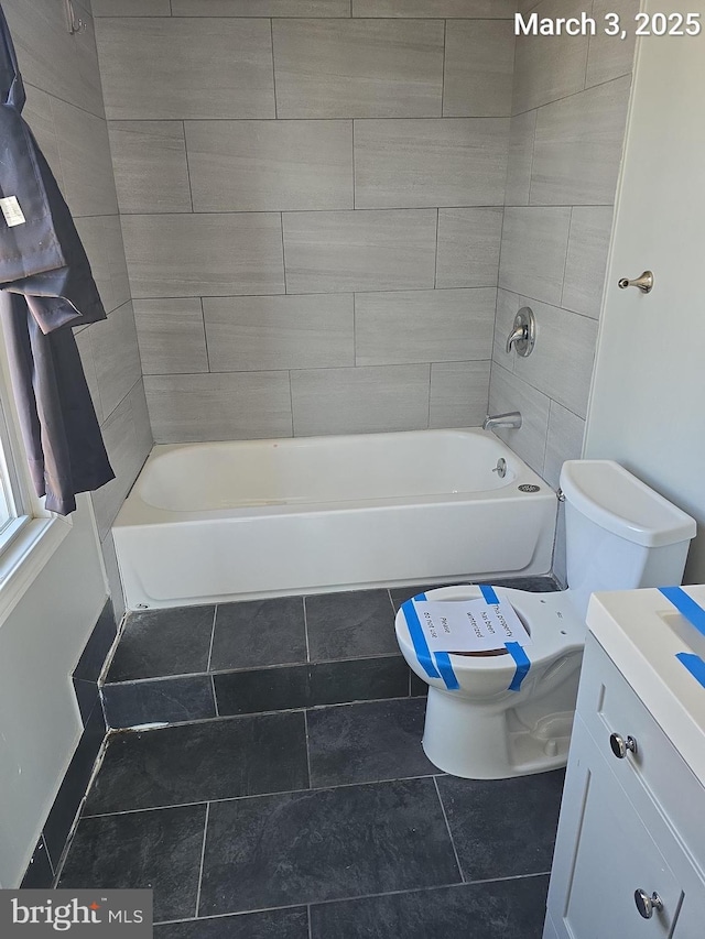 bathroom with tile patterned floors, tub / shower combination, toilet, and vanity