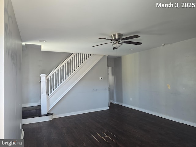 unfurnished living room with stairway, wood finished floors, baseboards, and ceiling fan