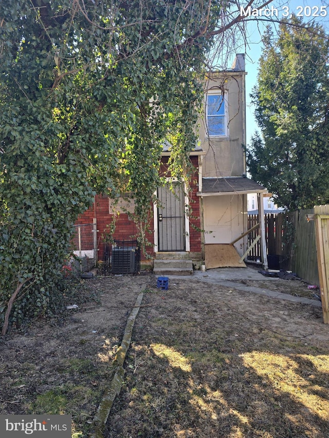 exterior space with fence and brick siding