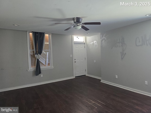 foyer featuring wood finished floors, baseboards, and ceiling fan