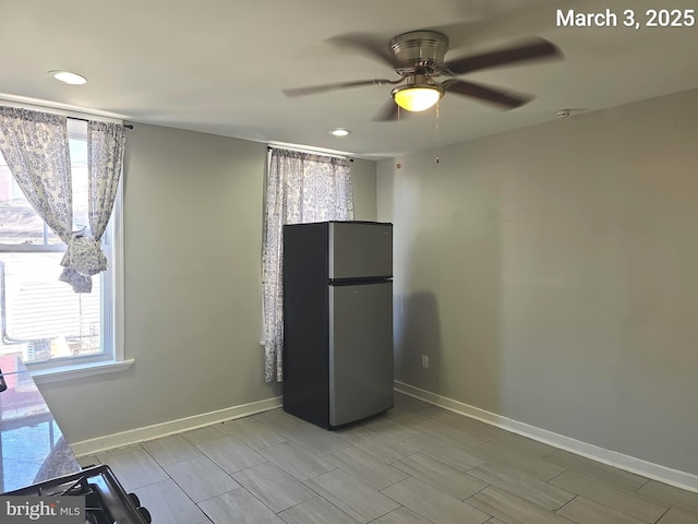 interior space with recessed lighting, baseboards, freestanding refrigerator, and ceiling fan