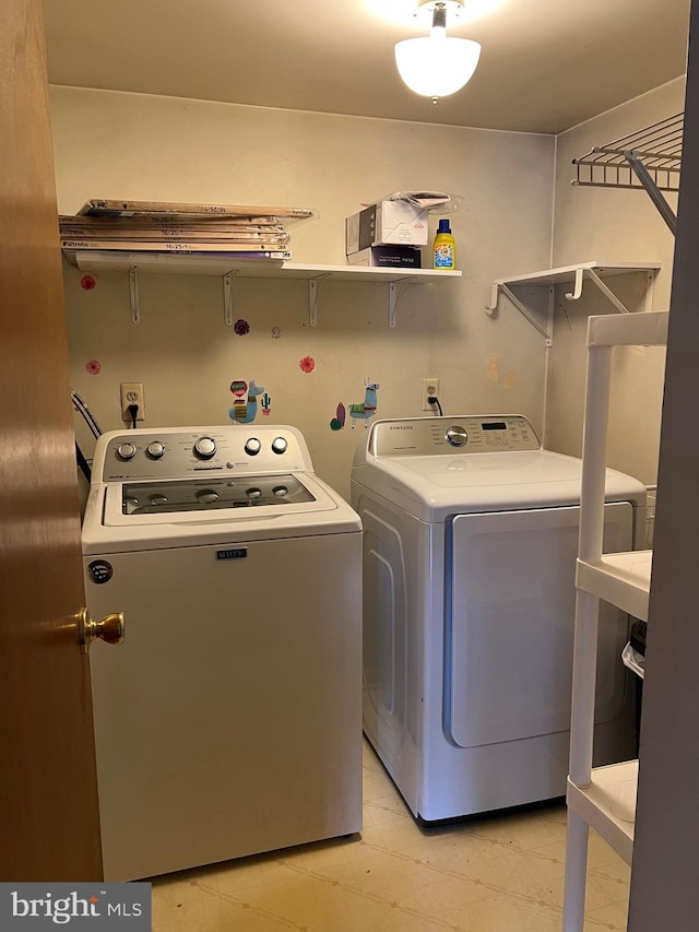 washroom featuring washing machine and dryer and laundry area