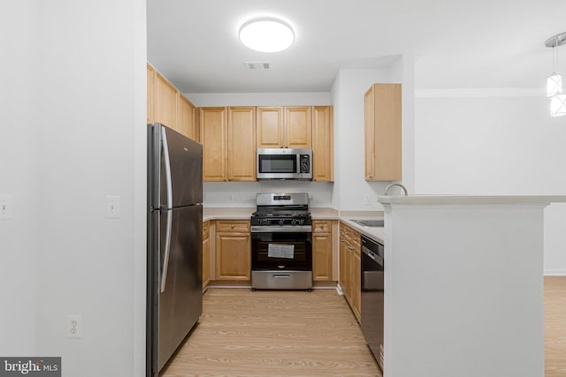 kitchen featuring a sink, stainless steel appliances, visible vents, and light wood-style flooring