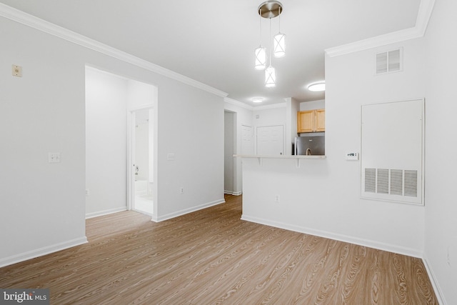 unfurnished living room featuring visible vents, baseboards, light wood-style floors, and ornamental molding