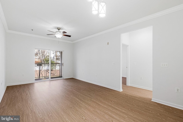 unfurnished room with ceiling fan, baseboards, wood finished floors, and crown molding