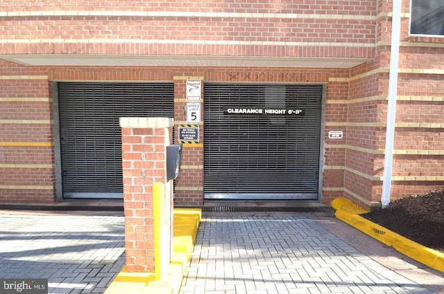 doorway to property with brick siding