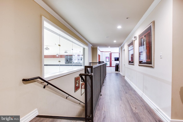 corridor with recessed lighting, baseboards, an upstairs landing, and wood finished floors