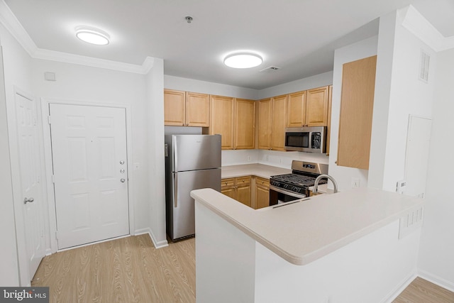 kitchen with visible vents, a peninsula, stainless steel appliances, light countertops, and light wood-type flooring