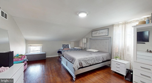 bedroom with dark wood-type flooring, baseboards, visible vents, and lofted ceiling