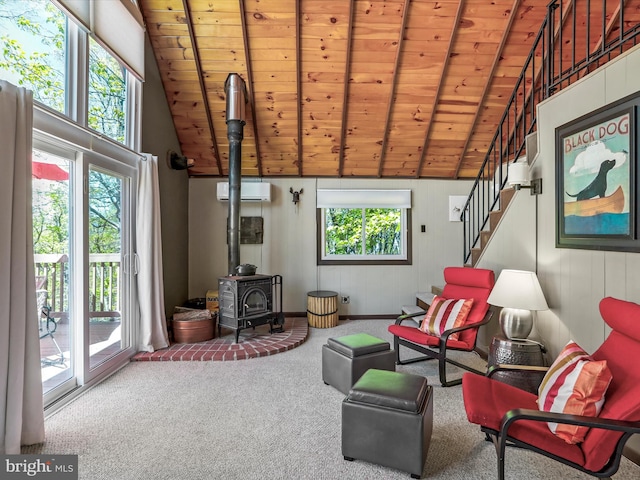 777 Timber Ln, Berkeley Springs, WV 25411 - sitting room featuring a wood stove, carpet floors, stairs, wooden ceiling, and a wall mounted AC