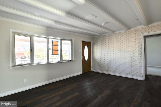 foyer featuring beamed ceiling, baseboards, dark wood-style floors, and brick wall