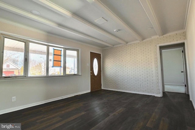 entrance foyer with beam ceiling, dark wood-style floors, baseboards, and brick wall