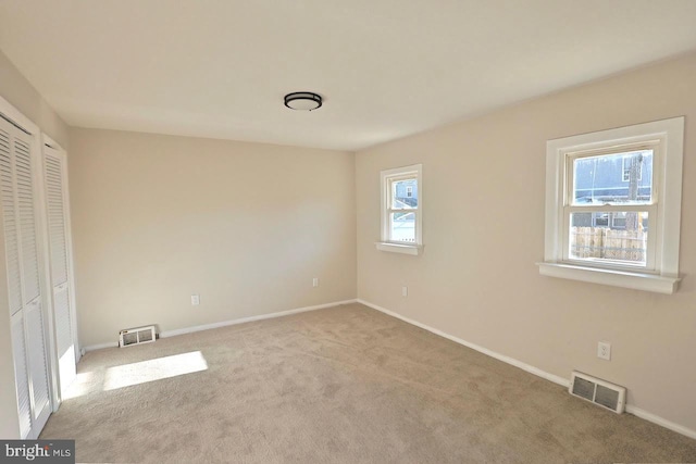 unfurnished bedroom with visible vents, baseboards, and carpet floors