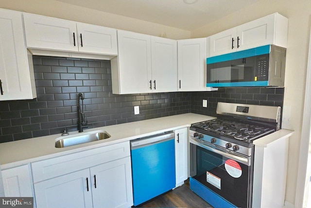 kitchen with stainless steel gas range oven, white cabinetry, dishwasher, and a sink