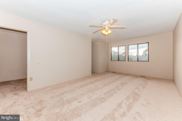 unfurnished room with carpet flooring and a ceiling fan