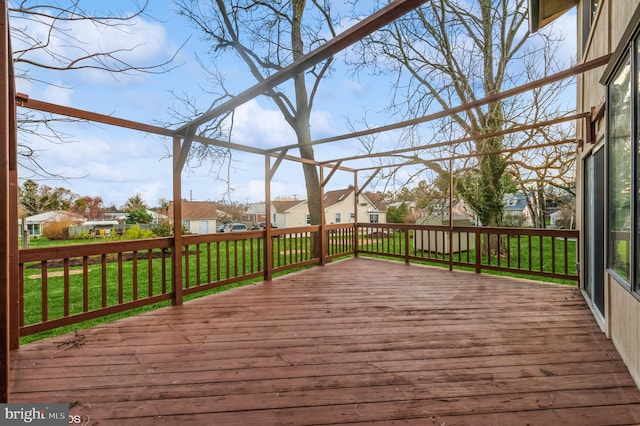 deck with a yard and a residential view