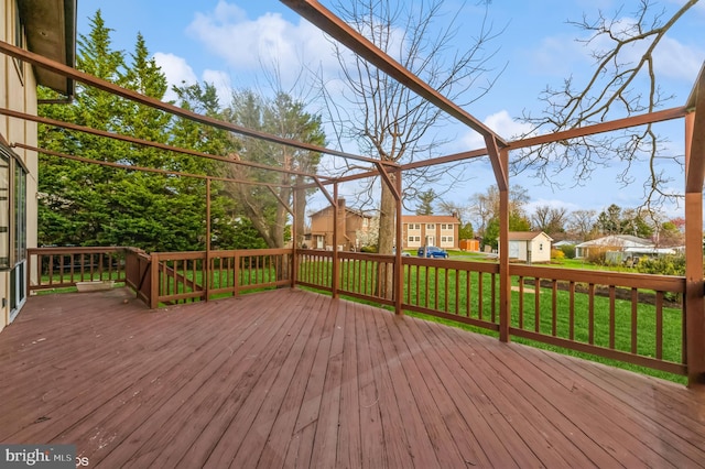 deck with a residential view and a yard