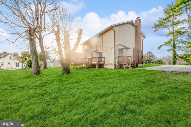 exterior space featuring a chimney and a yard