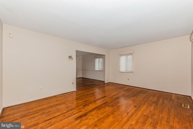 spare room with visible vents and wood finished floors