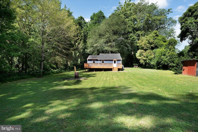 view of yard featuring an outbuilding and a wooden deck