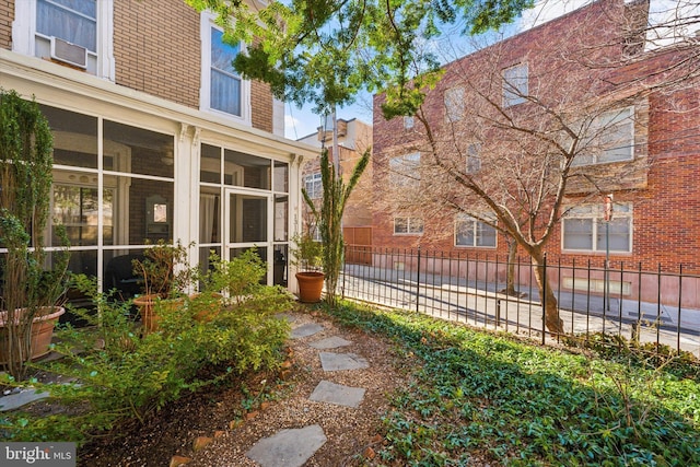 view of yard with fence and a sunroom