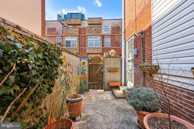 view of patio featuring fence and a gate