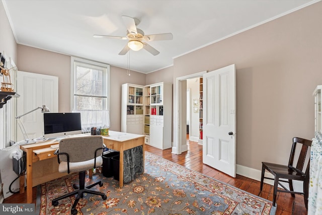 office featuring ornamental molding, baseboards, a ceiling fan, and wood-type flooring