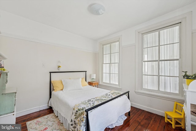 bedroom featuring baseboards and dark wood-type flooring