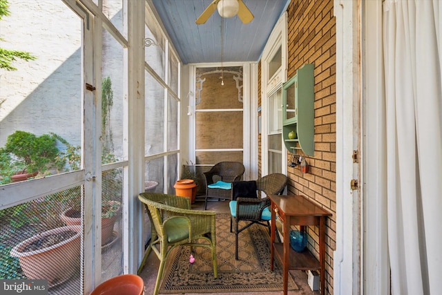 sunroom / solarium with a ceiling fan and a healthy amount of sunlight