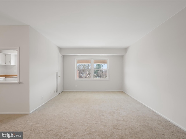 carpeted spare room with baseboards