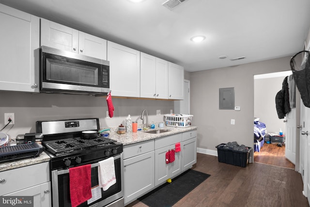 kitchen featuring a sink, white cabinets, dark wood-style floors, and stainless steel appliances