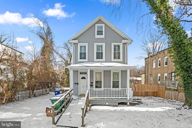 traditional home with a porch and fence