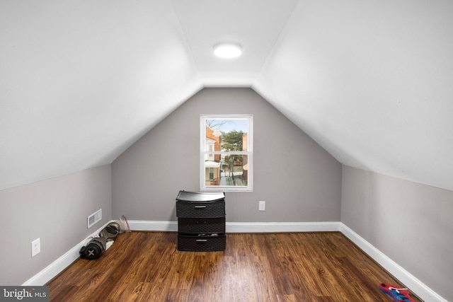 bonus room featuring visible vents, baseboards, wood finished floors, and vaulted ceiling