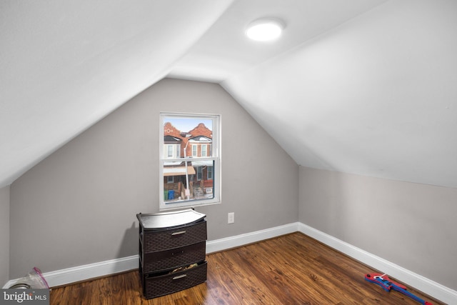 bonus room featuring vaulted ceiling, wood finished floors, and baseboards