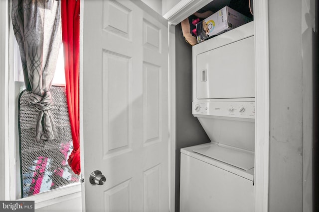 laundry room with stacked washer and dryer and laundry area