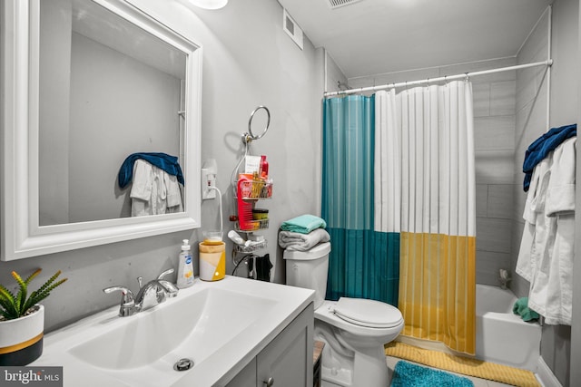 bathroom with vanity, shower / tub combo, toilet, and visible vents