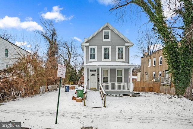 view of front facade featuring a porch and fence