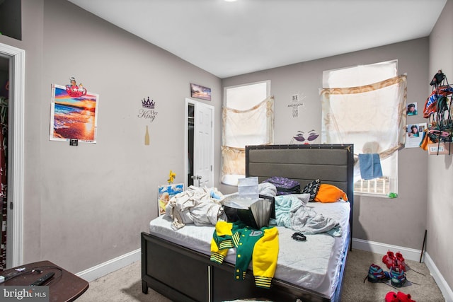 bedroom with carpet flooring and baseboards