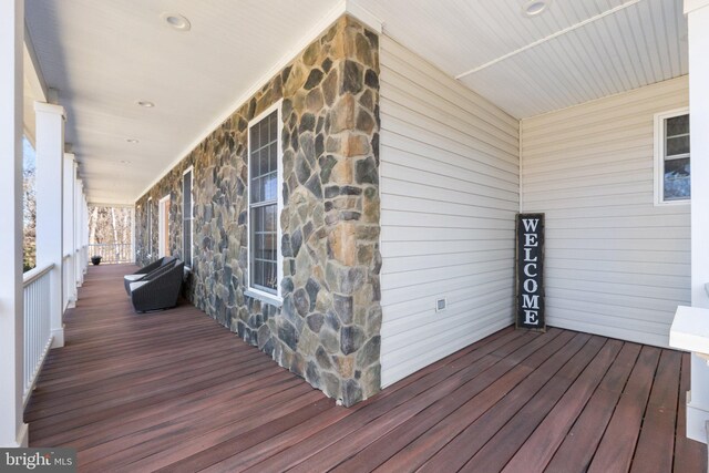 wooden terrace featuring covered porch