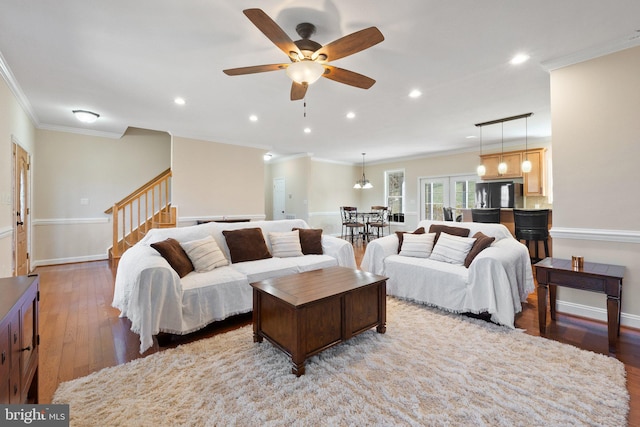 living room with crown molding, baseboards, stairway, recessed lighting, and wood-type flooring