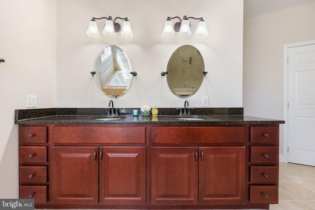 bathroom with double vanity, tile patterned flooring, and a sink